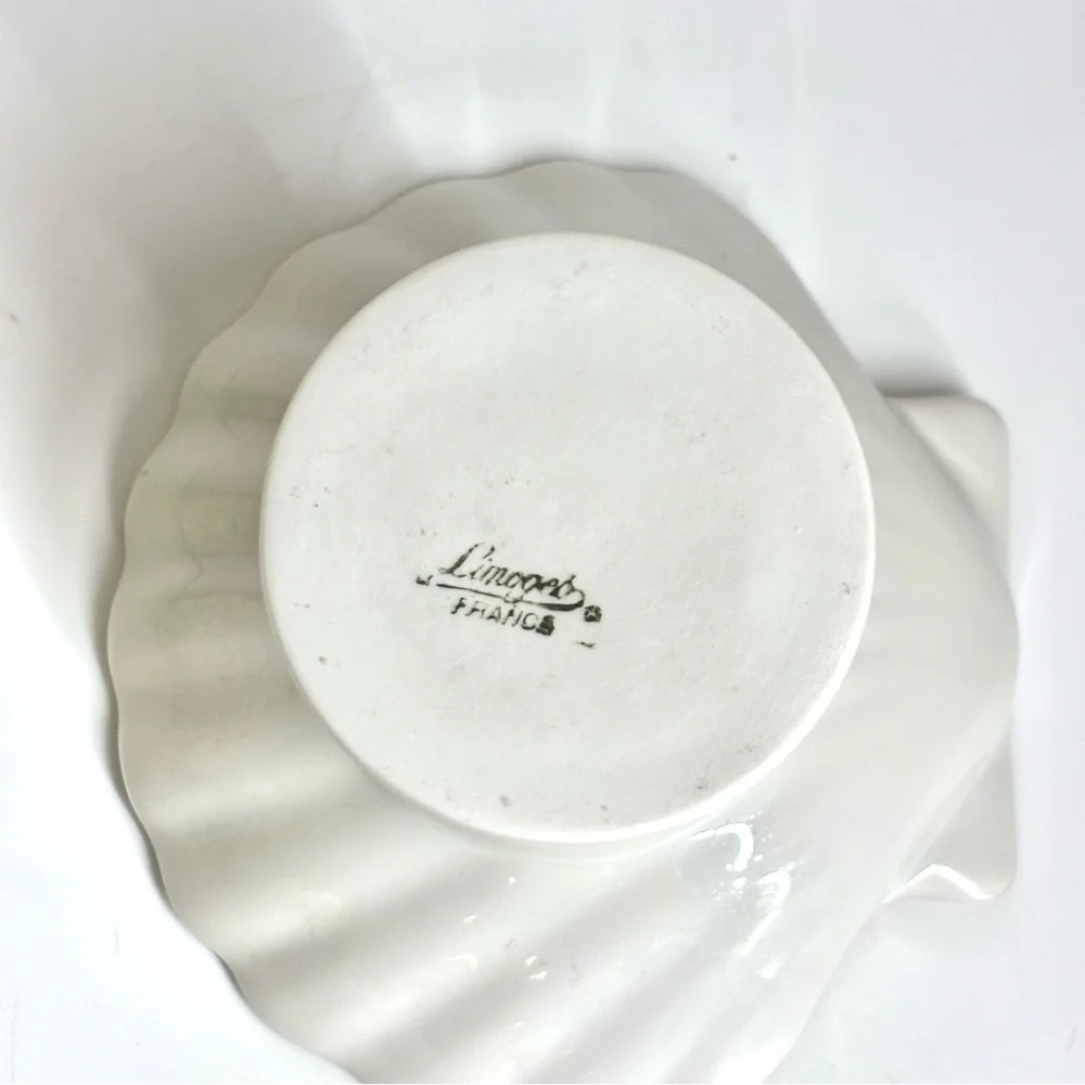 Vintage Limoges France porcelain shell-shaped pedestal dish.